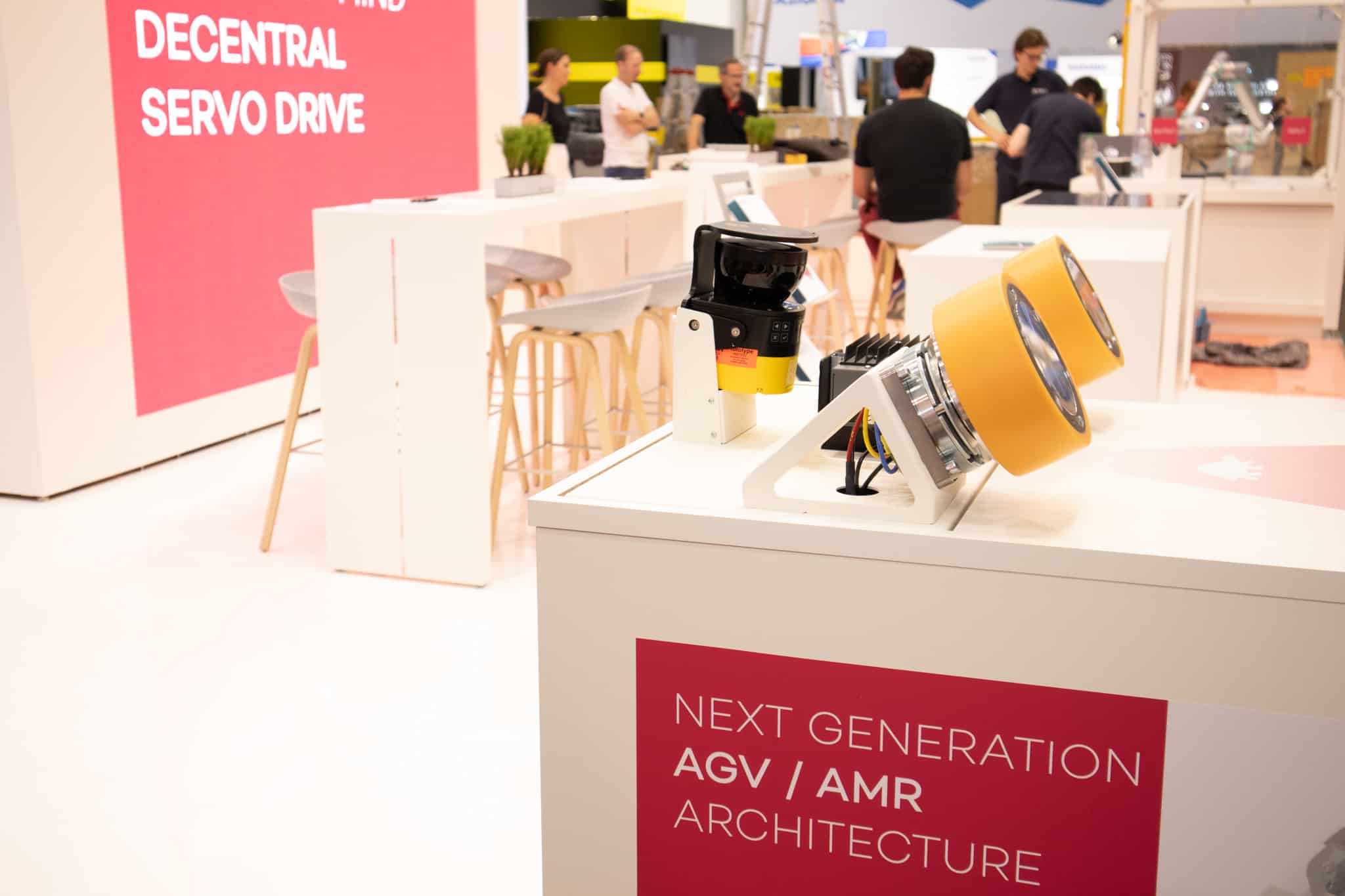 a group of people standing around a booth
