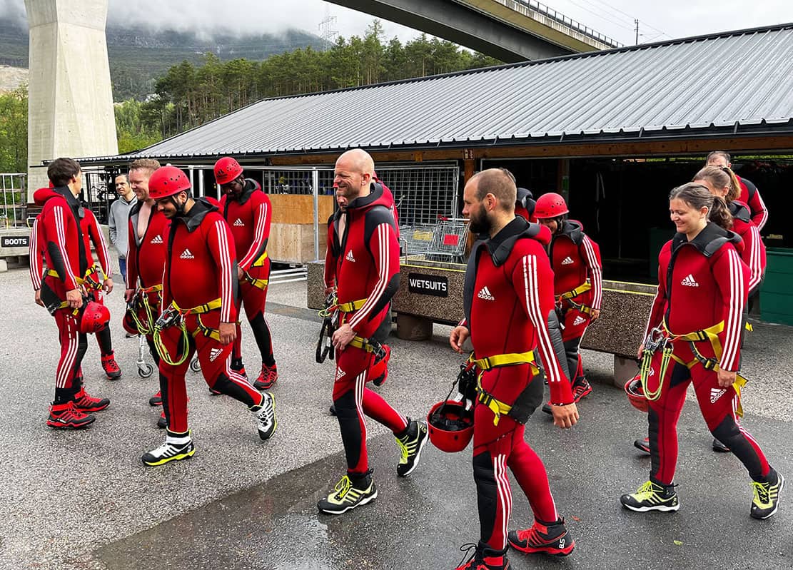 a group of people in red and black swimsuits during teambuilding activity